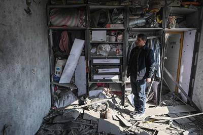 A man inspects a damaged house after several rockets land at Khair Khana, north west of Kabul. A series of loud explosions shook central Kabul on November 21, including several rockets that landed near the heavily fortified Green Zone where many embassies and international firms are based, officials said. AFP