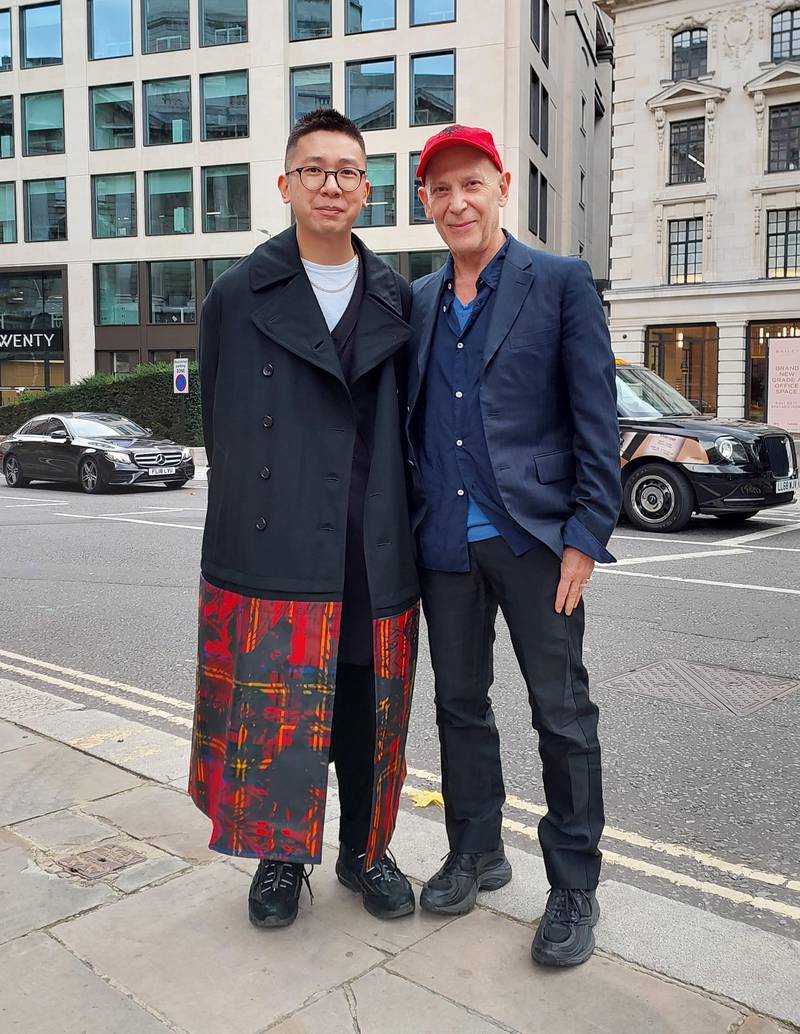 A coat trimmed with printed tartan and a matching red baseball cap.