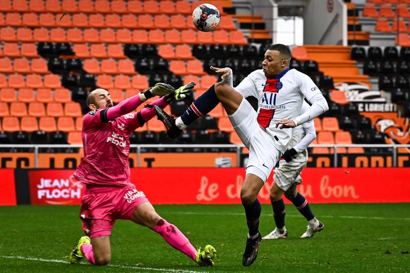 Lorient's French goalkeeper Matthieu Dreyerfights for the ball with Paris Saint-Germain's forward Kylian Mbappe. AFP