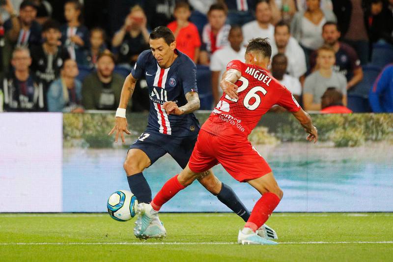 PSG's Angel Di Maria, left, challenges for the ball with Nimes' Florian Miguel. AP Photo