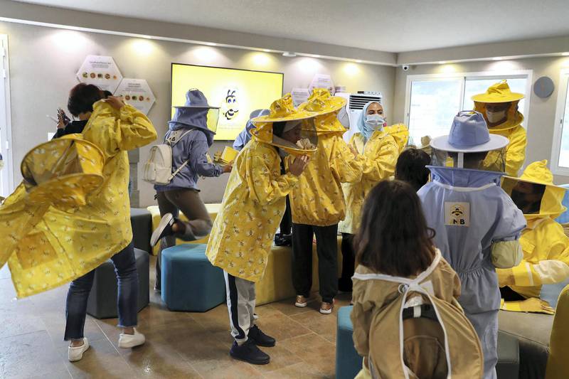 DUBAI, UNITED ARAB EMIRATES , November 7 – 2020 :- Visitors wearing protective beekeeping suits and face shields before the start of tour at the Hatta honey bee garden at the Hatta in Dubai. The ticket price of honey bee garden tour is 50 AED per person.  (Pawan Singh / The National) For News/Online/Instagram/Big Picture. Story by Nick Webster 