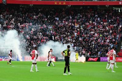 Ajax supporters throw fireworks onto the pitch during the Dutch Eredivisie soccer match between Ajax Amsterdam and Feyenoord Rotterdam in Amsterdam. EPA