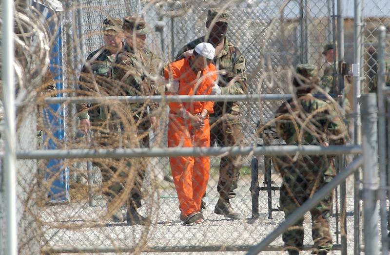 A detainee from Afghanistan is led by military police at Camp X-Ray at Guantanamo Bay. AP