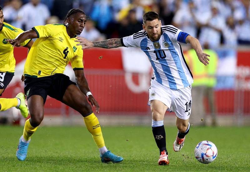 Argentina's Lionel Messi holds off the challenge of Amarii Bell of Jamaica. AFP