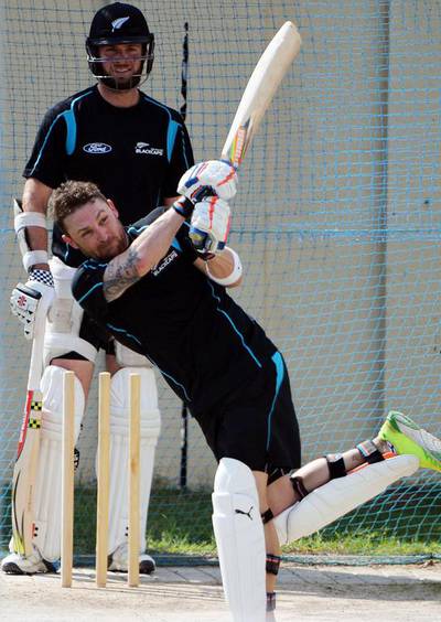 New Zealand cricket captain Brendon McCullum plays a shot as teammate Mark Craig looks on during net practice session at the Sharjah Cricket Stadium on November 24, 2014. The series-deciding third Test between Pakistan and New Zealand starts at Sharjah on November 26, 2014. Aamir Qureshi / AFP