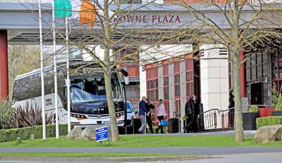 Airline passengers in Dublin leave the bus to enter the Crowne Plaza hotel to begin their period of quarantine. Image: Getty Images