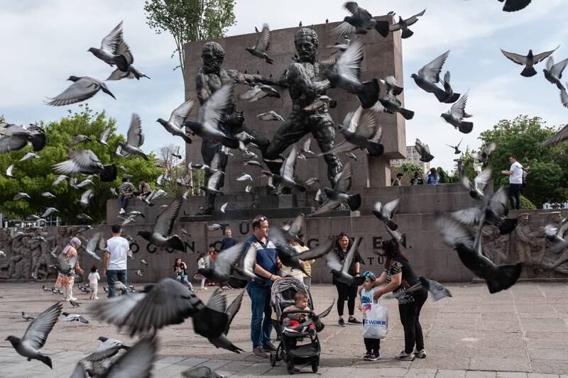 People stand in front of the Guven Monument in Ankara. Getty