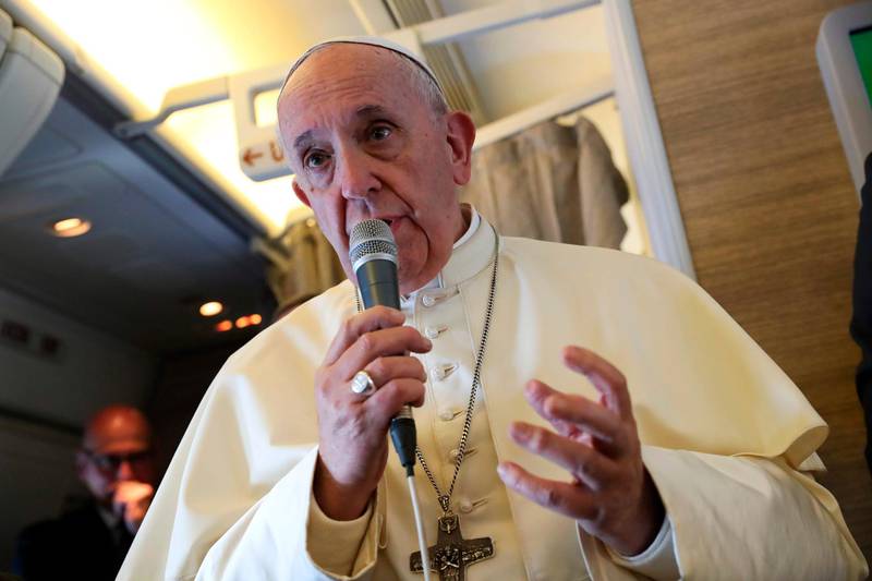 Pope Francis speaks to reporters aboard a plane on the way to Abu Dhabi. AFP