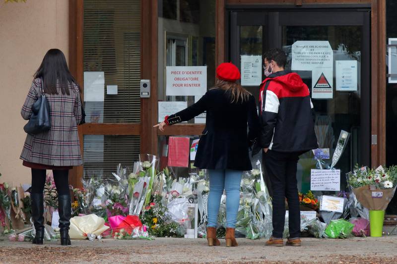 Teachers and the public lay flowers in front of Bois d'Aulne middle school to pay their respect after a teacher was assassinated in Conflans Sainte-Honorine. AP
