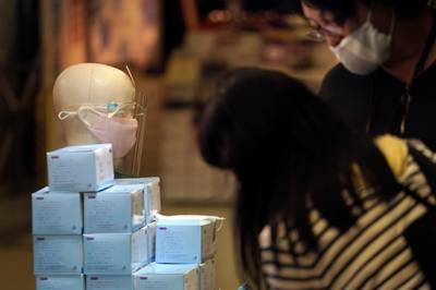 Protective face masks to help curb the spread of the coronavirus are sold at a shop in Tokyo, Japan. AP Photo