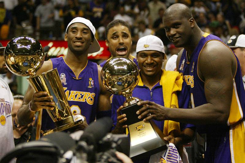Bryant, holding the championship trophy, celebrates with teammates Rick Fox, Lindsey Hunter and Shaquille O'Neal in 2002. AP