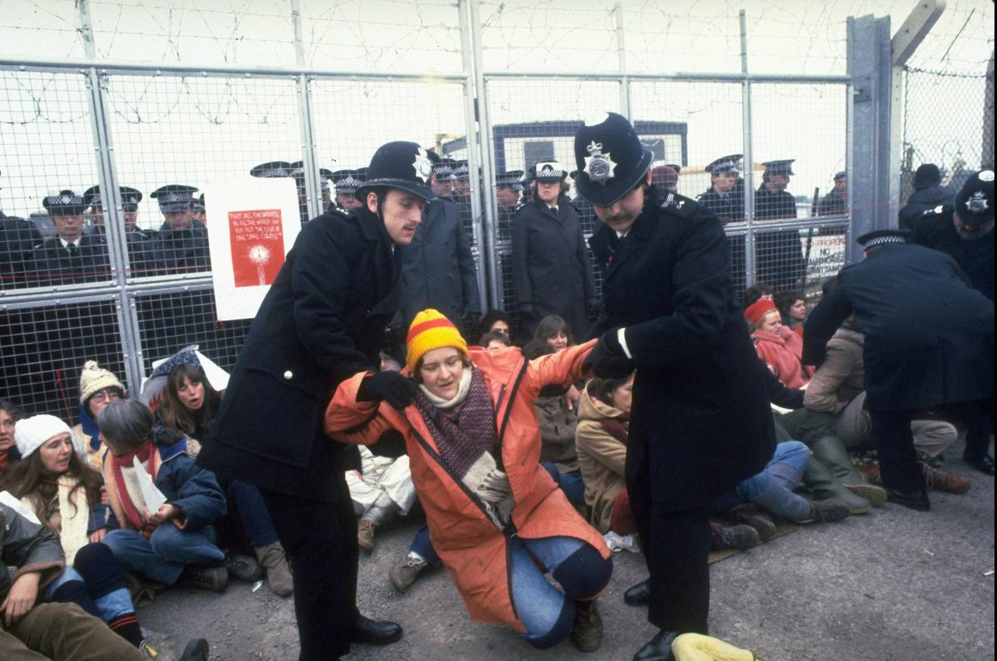 British police officers dragging protestor participating in anti-nuclear missle demonstration outside Greenham Common Air Base during arrival of US Tomahawk cruise missiles.  (Photo by Sahm Doherty/The LIFE Images Collection via Getty Images/Getty Images)