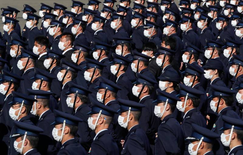 Japan's Air Self-Defense Force personnel stand while being reviewed by Japanese Prime Prime Minister Yoshihide Suga at Iruma Air Base in Sayama, northwest of Tokyo. Pool Photo via AP