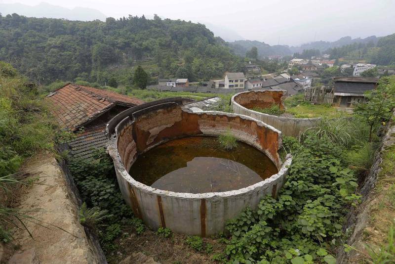Two disused tanks are seen at a closed realgar mining plant at Heshan village. Jason Lee / Reuters