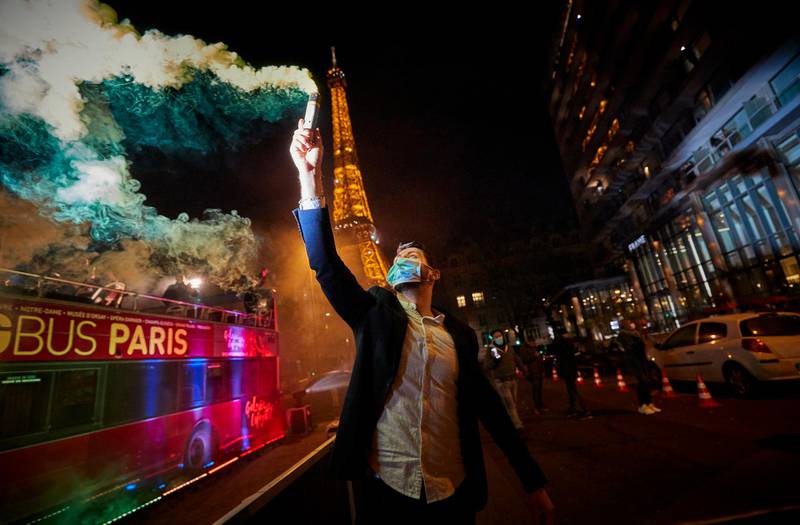 Parisians ring in the New Year 2021 near the Eiffel Tower. New Year's eve celebrations and fireworks have been cancelled throughout France with an 8 o'clock curfew imposed in a bid to curb the spread of Covid-19 infections. Getty Images