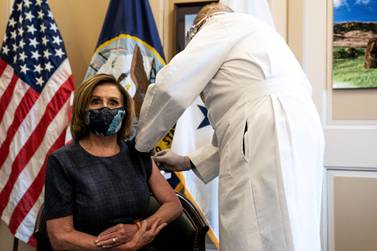 US Speaker of the House Nancy Pelosi receives the Pfizer-BioNTech COVID-19 vaccine from Dr Brian Monahan, Washington, DC, December 18, 2020. Pool via REUTERS 