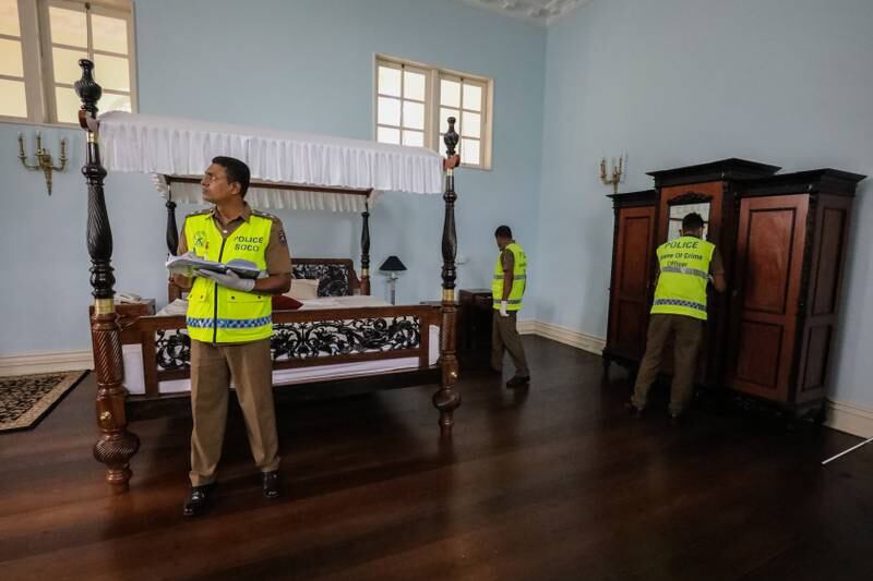 Crime investigation officers in the palace after the protesters' occupation. EPA