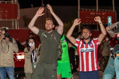 Atletico players Jan Oblak, left, and Koke celebrate winning La Liga with supporters at Wanda Sport City. EPA