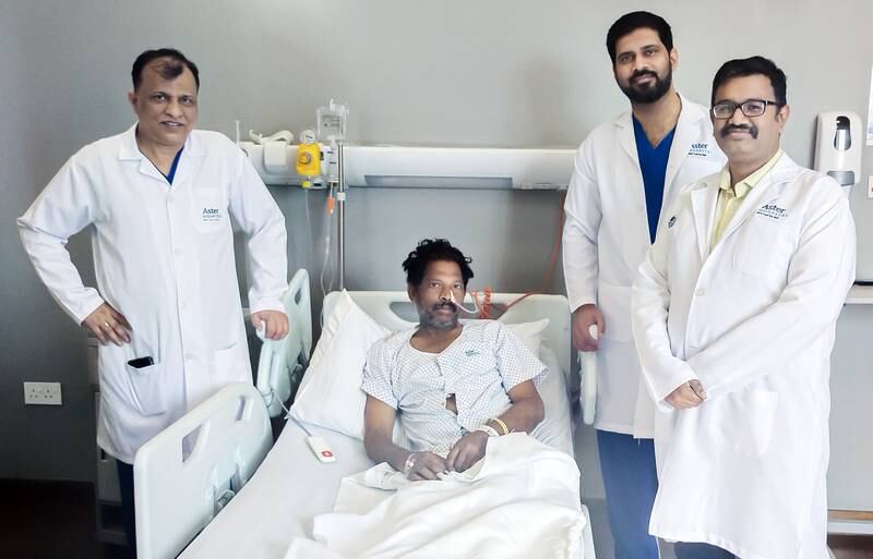 Doctors Debrabata Dash, Naveed Ahmed, and Senthilnathan TT with P Shajikuttan at Aster Hospital, Mankhool. Photo: Aster Hospital