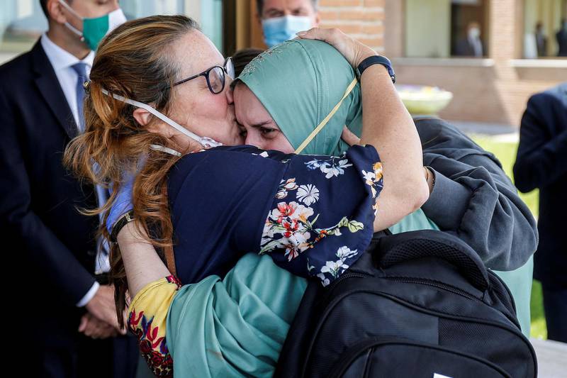 Silvia Romano, an Italian aid worker who was kidnapped by gunmen in Kenya 18 months ago, is kissed by her mother, Francesca Fumagalli, at Ciampino military airport in Rome, Italy.  Reuters