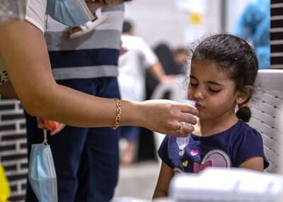 Perla Mansour, 4, takes a saliva test before the start of the new school term. All photos: Victor Besa / The National