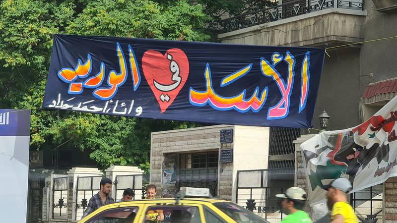 A banner in Bagdad street reads "Assad in my veins" 