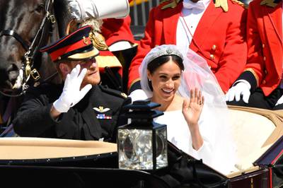 WINDSOR, ENGLAND - MAY 19:  Prince Harry, Duke of Sussex and Meghan, Duchess of Sussex leave Windsor Castle in the Ascot Landau carriage during a procession after getting married at St Georges Chapel on May 19, 2018 in Windsor, England. Prince Henry Charles Albert David of Wales marries Ms. Meghan Markle in a service at St George's Chapel inside the grounds of Windsor Castle. Among the guests were 2200 members of the public, the royal family and Ms. Markle's Mother Doria Ragland.  (Photo by Leon Neal/Getty Images)