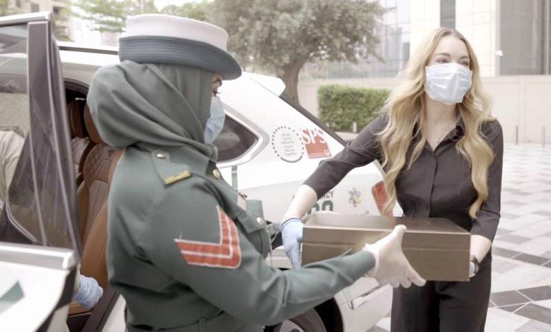 Lindsay Lohan safely covered up with gloves and a mask when she met members of Dubai Police. Instagram / Lindsay Lohan 