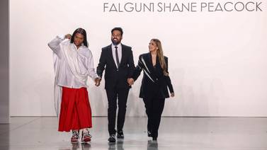 Stylist Law Roach, left, joins Shane and Falguni Peacock at the Indian designer duo's show during New York Fashion Week. AP