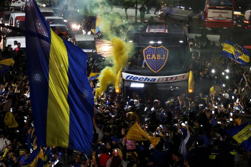 A bus transporting Boca Juniors players is received by fans near the La Bombonera stadium in Buenos Aires. EPA