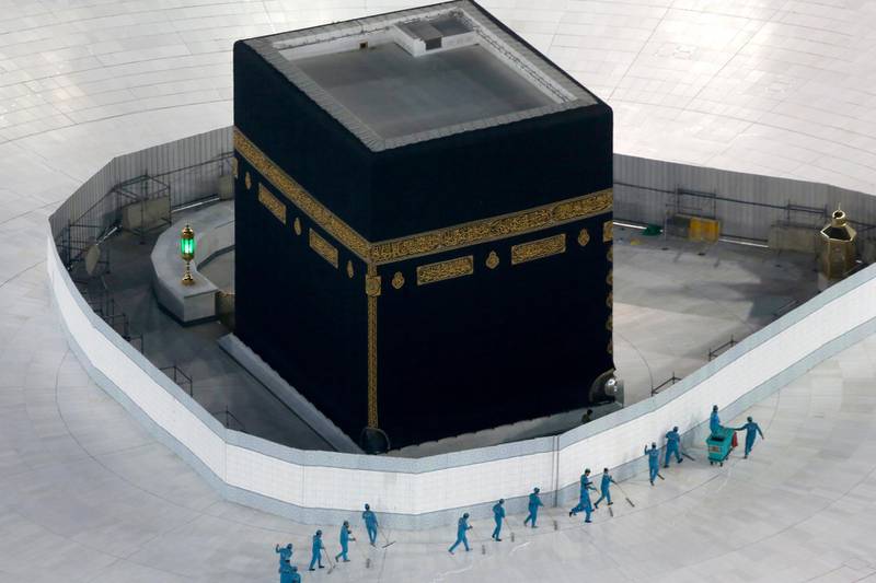 Workers disinfect the ground around the Kaaba, the cubic building at the Grand Mosque, in the Muslim holy city of Makkah. AP