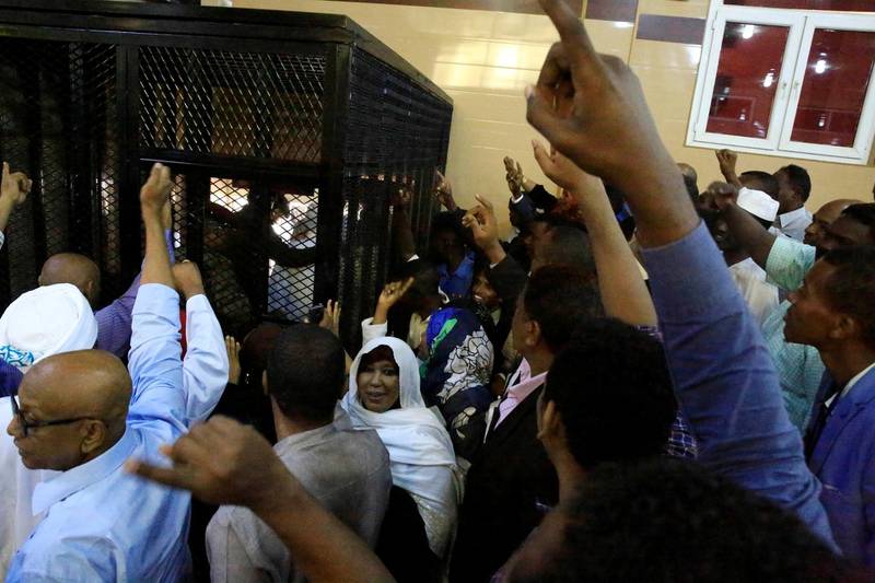 Relatives and supporters of Bashir cheer him. Reuters