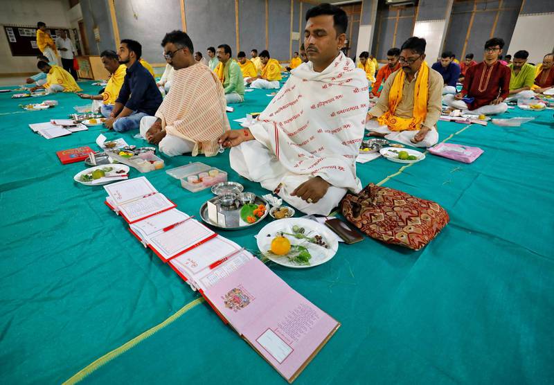 Indian businessmen pray in front of their record-keeping books as part of a ritual to worship the Hindu deity of wealth goddess Lakshmi in Ahmedabad, India. Reuters