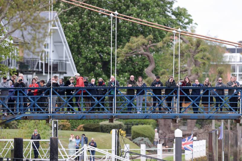People on a bridge over the Thames trying to see the whale swimming past. Reuters