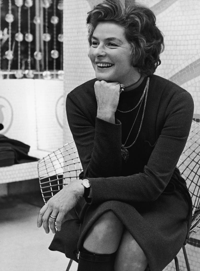 Swedish film and theater actress Ingrid Bergman (1915 - 1982) sits on a wire chair with her hand on her chin and laughs, London, January 6, 1971. Bergman was in London for her role as Lady Waynflete in George Bernard Shaw's 'Captain Brassbound's Conversion' at the Cambridge Theatre. (Photo by Express Newspapers/Getty Images)