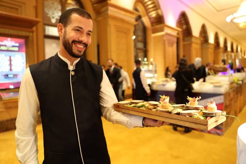 A waiter serves canapes ahead of the unveiling. 