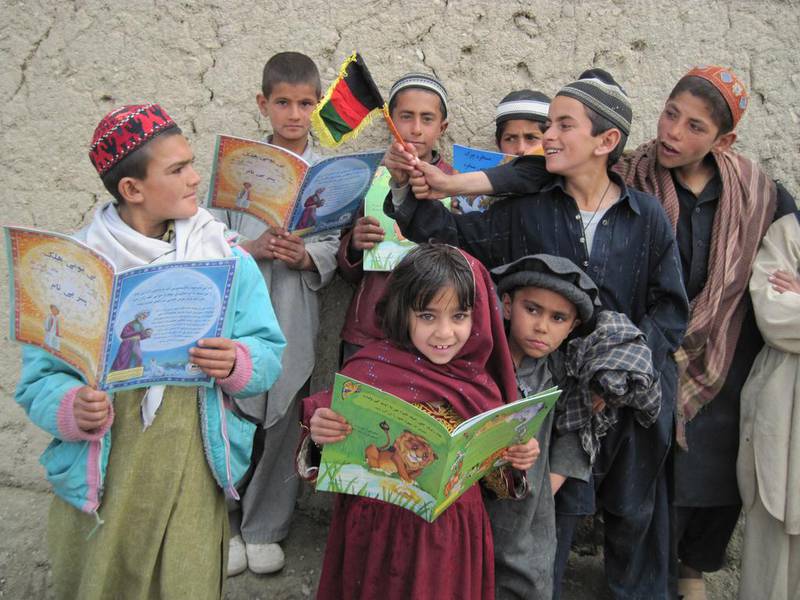 Children enjoy storytelling as a respite from conflict in Paktika Province, Afghanistan. Hoopoe Books has distributed more than 4.5 million bilingual books to children in Afghanistan and Pakistan, and has also reached 600,000 disadvantaged youngsters in the Americas.   Courtesy Hoopoe Books