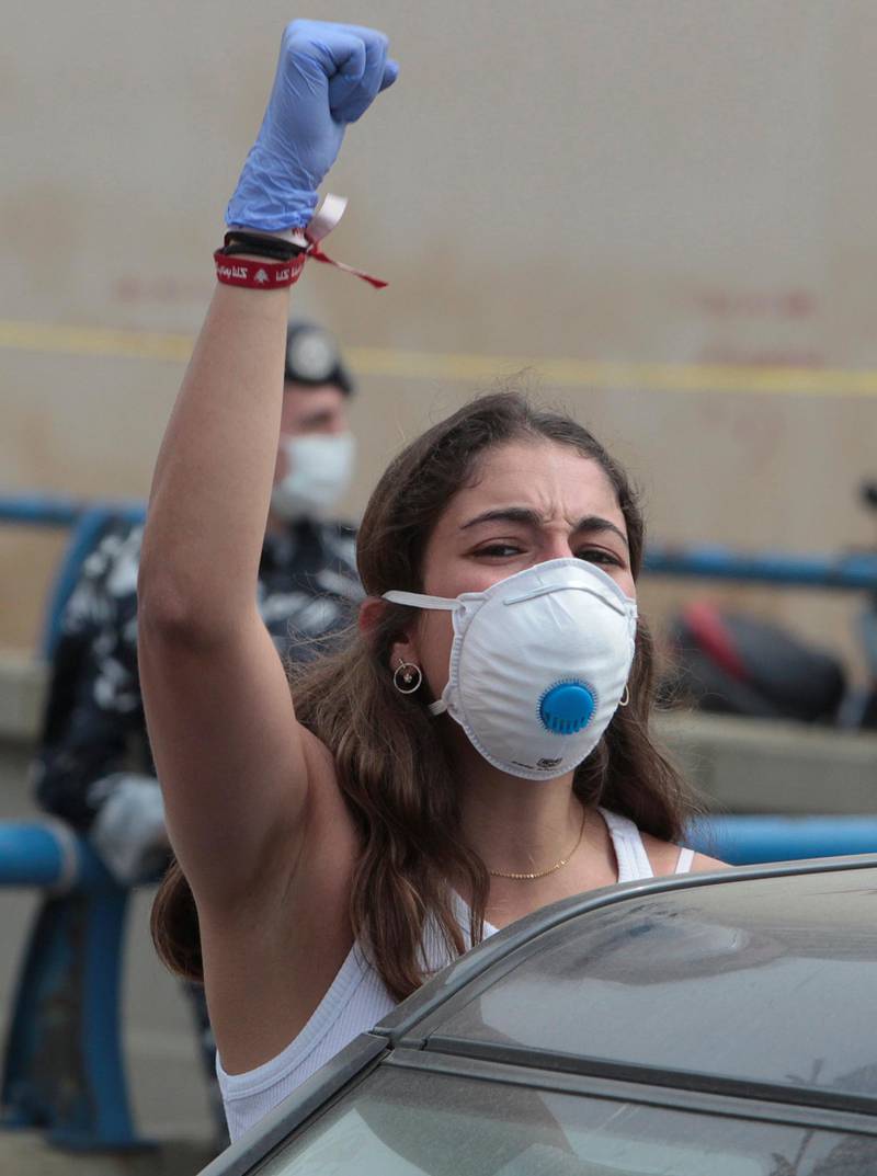 An anti-government demonstrator wearing a face mask gestures during a protest, amid a countrywide lockdown to combat the spread of the coronavirus disease in Beirut, Lebanon.  Reuters