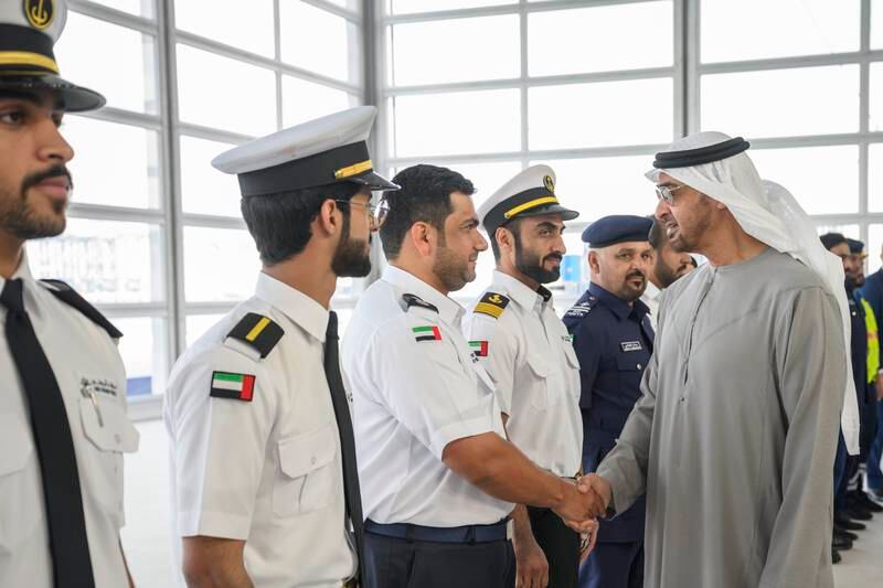 Sheikh Mohamed greets an employee of Abu Dhabi Ports