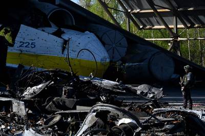 A serviceman stands guard at the destroyed Ukrainian Antonov An-225 'Mriya' cargo aircraft in Hostomel. AFP