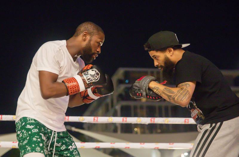 Floyd Mayweather Jr and Deji Olatunji attend a training prior to their boxing match in Dubai. Getty