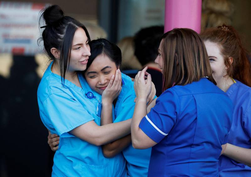 NHS workers at the Aintree University Hospital react during the last day of the Clap for our Carers campaign in support of the NHS in Liverpool, Britain. Reuters