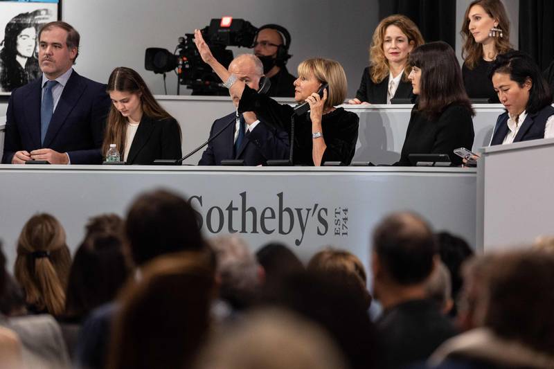 Sotheby's staff take calls for off-site bids during an auction of The Macklowe Collection, at Sotheby's on November 15, 2021 in New York City. AFP