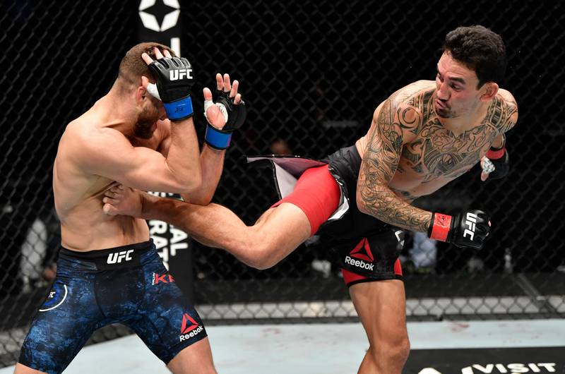 ABU DHABI, UNITED ARAB EMIRATES - JANUARY 17: (R-L) Max Holloway kicks Calvin Kattar in a featherweight bout during the UFC Fight Night event at Etihad Arena on UFC Fight Island on January 17, 2021 in Abu Dhabi, United Arab Emirates. (Photo by Jeff Bottari/Zuffa LLC)