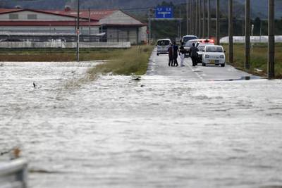 A submerged road in Saito, Japan. Nanmadol brought much of the country's transport to a standstill. AP