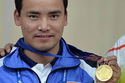 India's Jitu Rai poses with his gold medal after winning the men's 50m pistol individual final of the 2014 Asian Games in Incheon. Manan Vatsyayana / AFP