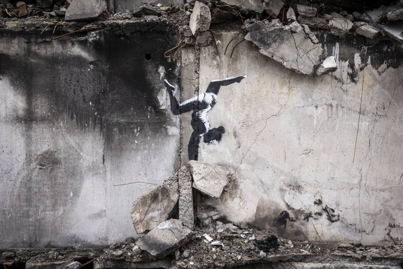 BORODYANKA, UKRAINE - NOVEMBER 11 Graffiti of a woman in a leotard doing a handstand is seen on the wall of a destroyed building in Borodyanka on November 11, 2022 in Kyiv Region, Ukraine. Similar art work nearby sparked online speculation over whether the graffiti artist Banksy has been working in Ukraine. Borodyanka was hit particularly hard by Russian airstrikes in the first few weeks of the conflict. Electricity and heating outages across Ukraine caused by missile and drone strikes to energy infrastructure have added urgency to preparations for winter. (Photo by Ed Ram / Getty Images)
