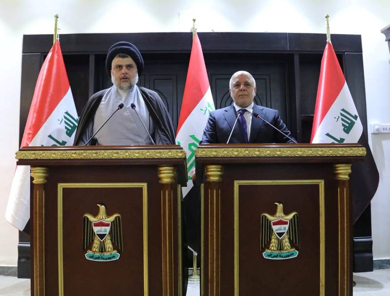 Iraqi Shi'ite cleric Moqtada al-Sadr (L) speaks during a news conference with Iraqi prime Minister Haider al-Abadi in Baghdad, Iraq May 20, 2018. Iraqi Prime Minister Media Office/Handout via REUTERS ATTENTION EDITORS - THIS IMAGE WAS PROVIDED BY A THIRD PARTY. NO RESALES. NO ARCHIVES