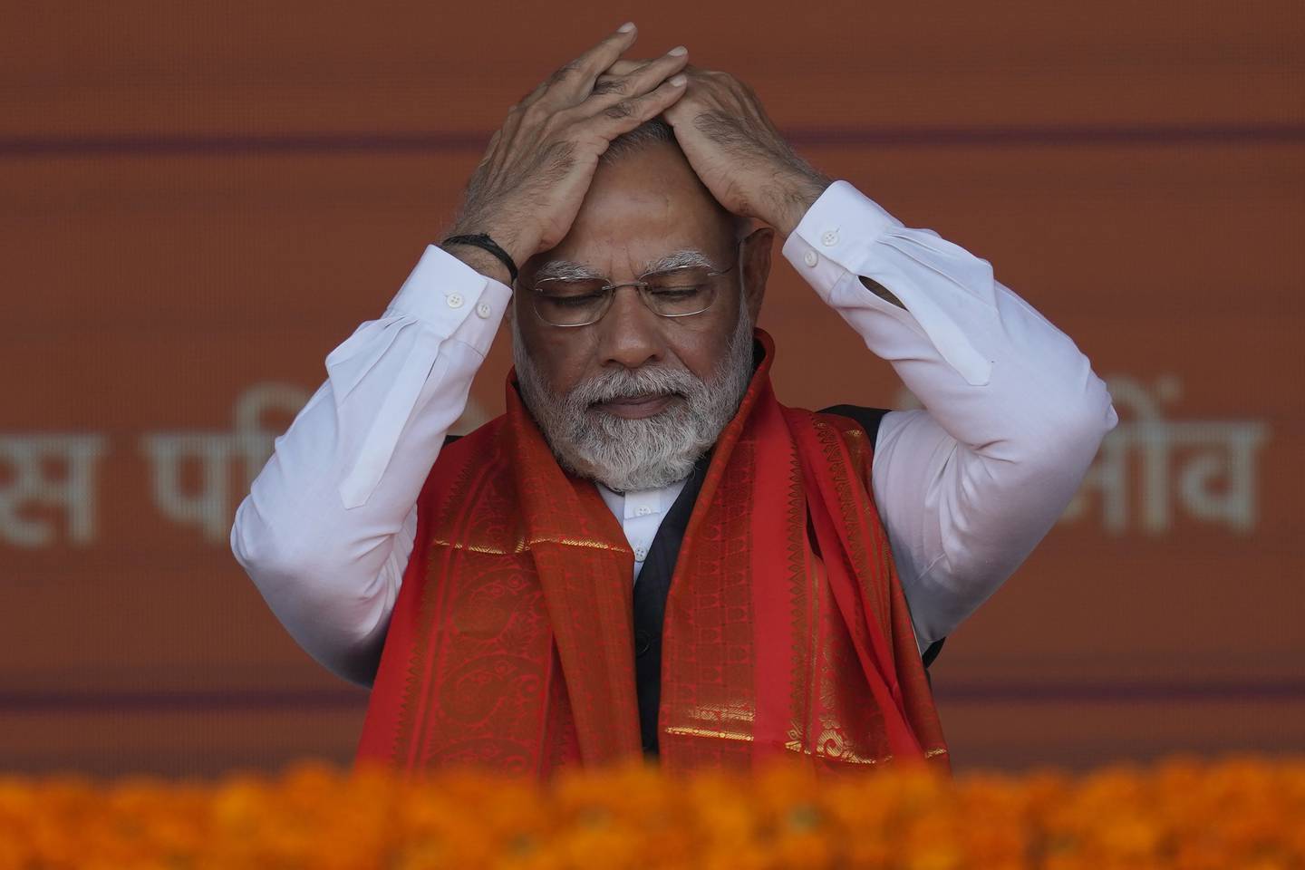 Indian Prime Minister Narendra Modi adjusts his hair during a rally in Mumbai, India. The Indian leader will host Egyptian President Abdel Fattah El Sisi later this week in Ne Delhi. AP
