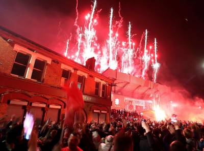 Liverpool fans celebrate outside Anfield as fireworks are set off. AP